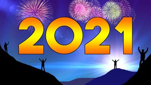 2021 in orange text over sillhouette hills with men lifting arms and fireworks